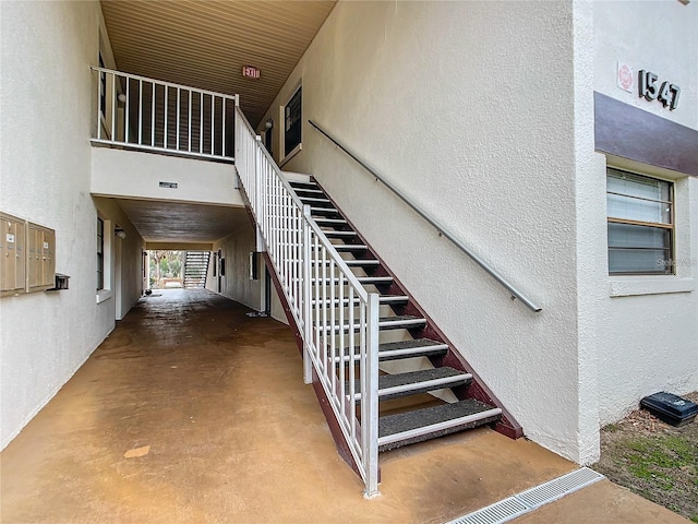 stairs featuring concrete floors