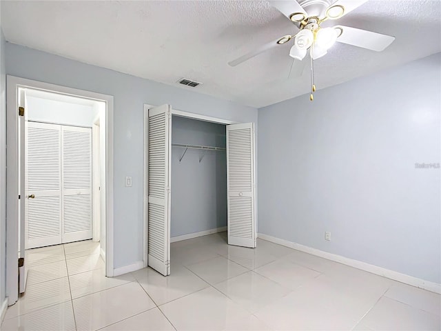 unfurnished bedroom with ceiling fan and light tile patterned floors