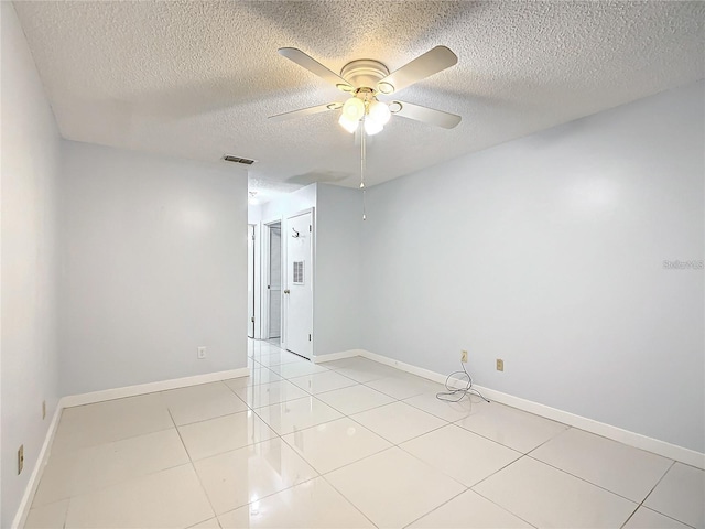 tiled spare room with ceiling fan and a textured ceiling