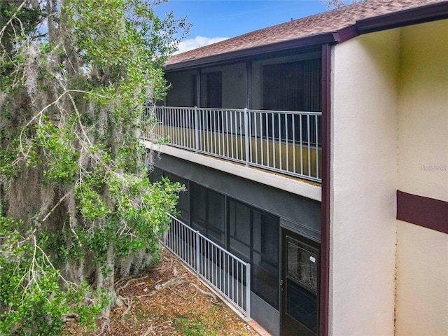 view of side of home featuring a balcony