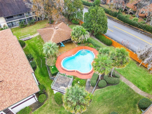 view of pool with a lawn and a trampoline