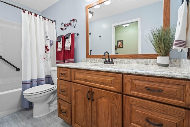 full bathroom with shower / tub combo with curtain, vanity, a textured ceiling, and toilet