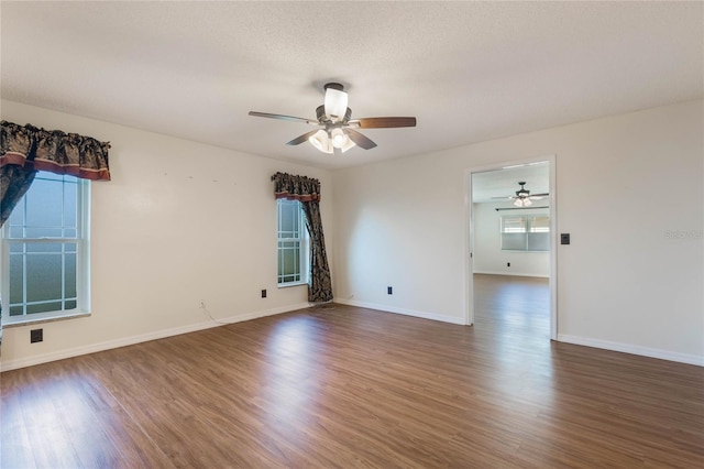 spare room featuring ceiling fan, dark hardwood / wood-style flooring, and a textured ceiling