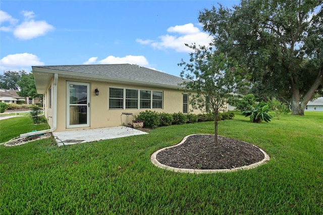 back of property featuring a patio area and a yard