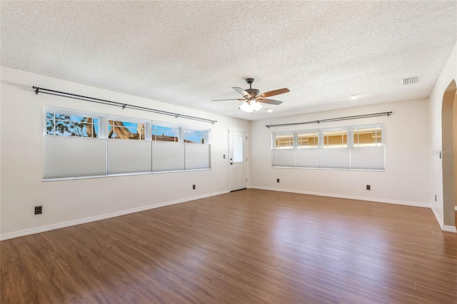 spare room with ceiling fan, wood-type flooring, and a textured ceiling