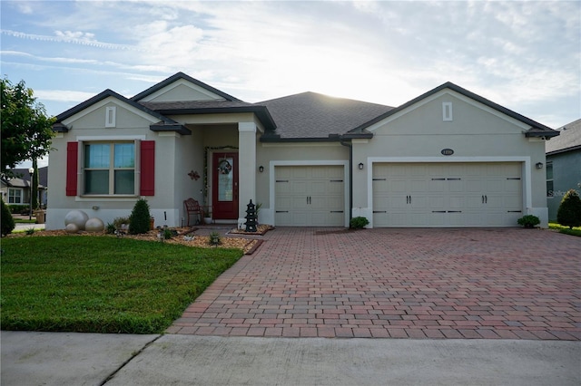 ranch-style home featuring a garage and a front lawn