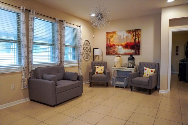 sitting room featuring baseboards, a chandelier, and light tile patterned flooring