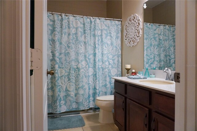 bathroom featuring toilet, a shower with shower curtain, tile patterned flooring, and vanity