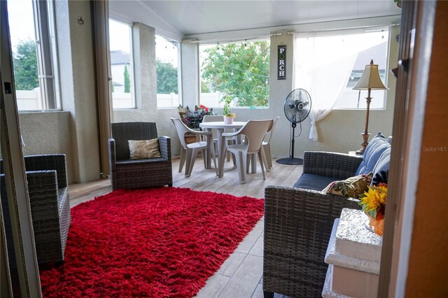 sunroom featuring a wealth of natural light and vaulted ceiling