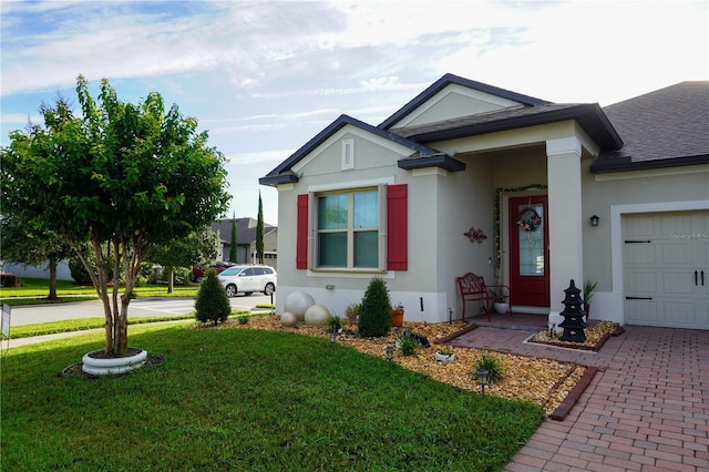 view of front facade with a shingled roof, a front lawn, stucco siding, decorative driveway, and a garage