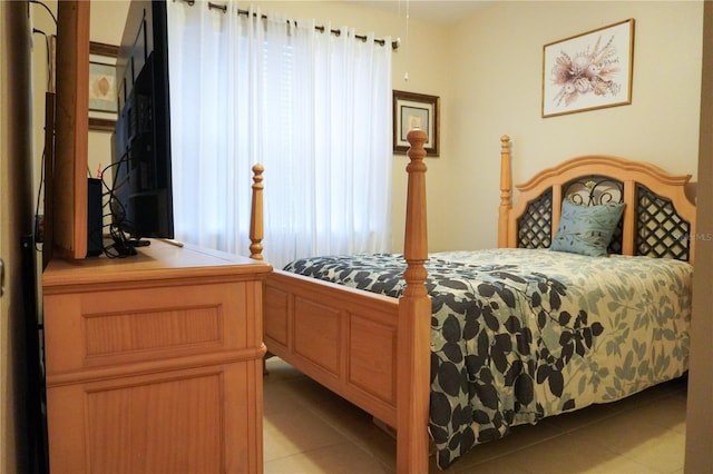 bedroom featuring multiple windows and light tile patterned flooring