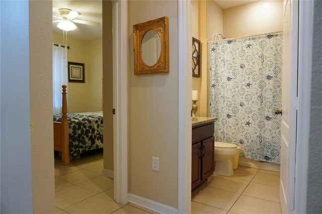 corridor featuring light tile patterned floors and baseboards