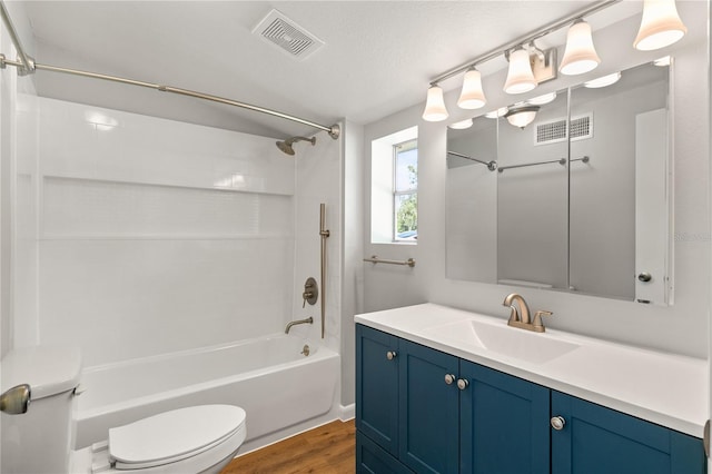 19402 E 5th St, Umatilla, FL 32784 - bathroom featuring toilet, wood finished floors, washtub / shower combination, and vanity