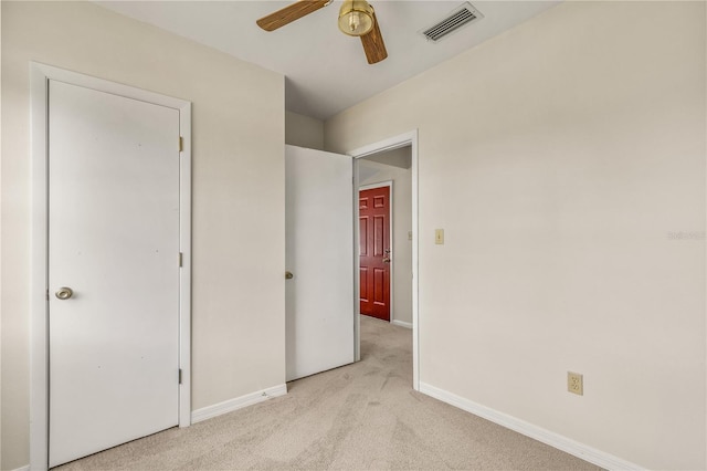 19402 E 5th St, Umatilla, FL 32784 - unfurnished bedroom with carpet, baseboards, and ceiling fan