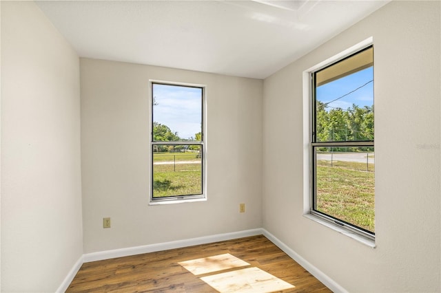 19402 E 5th St, Umatilla, FL 32784 - spare room featuring wood finished floors and baseboards
