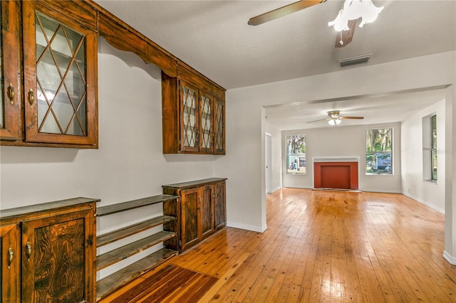 19402 E 5th St, Umatilla, FL 32784 - unfurnished living room with ceiling fan, baseboards, and light wood-style flooring