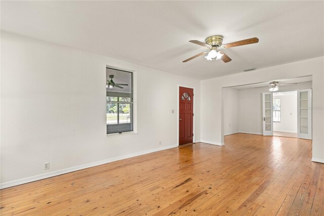 19402 E 5th St, Umatilla, FL 32784 - empty room with a ceiling fan, plenty of natural light, baseboards, and light wood finished floors