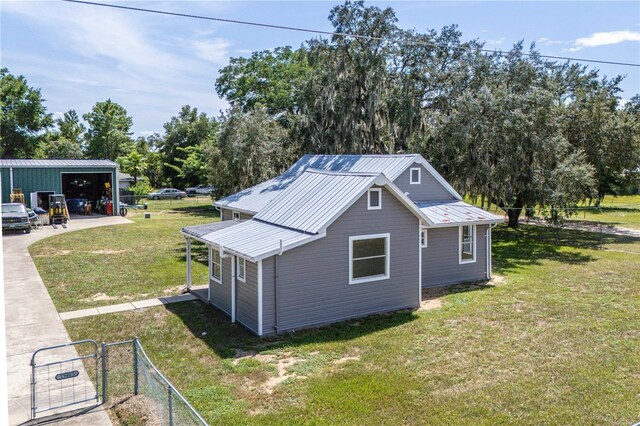 19402 E 5th St, Umatilla, FL 32784 - view of outbuilding with an outbuilding, a garage, and view of scattered trees