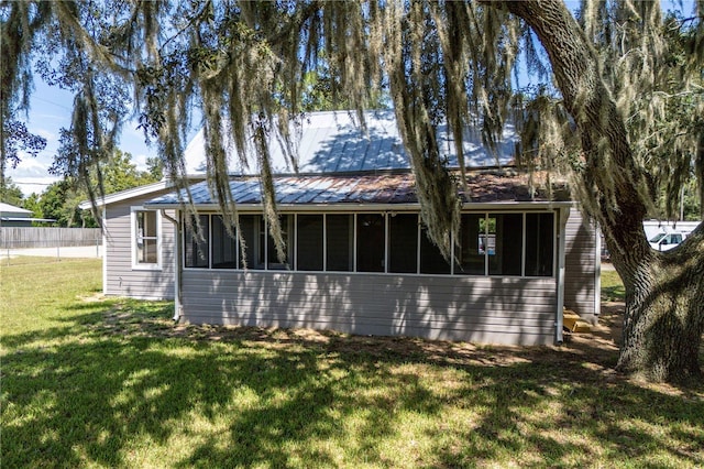 19402 E 5th St, Umatilla, FL 32784 - back of property with a sunroom and metal roof