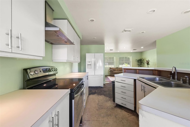 kitchen featuring sink, white fridge with ice dispenser, premium range hood, stainless steel electric range oven, and white cabinets