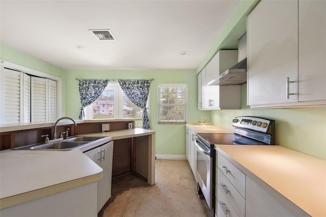 kitchen with wall chimney exhaust hood, white cabinets, stainless steel electric range, and sink