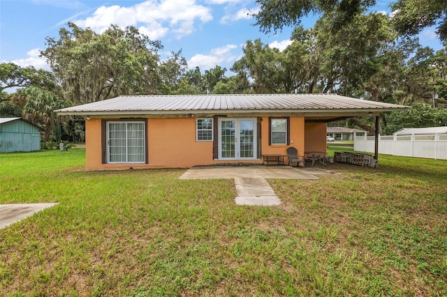 rear view of property with a patio area and a lawn