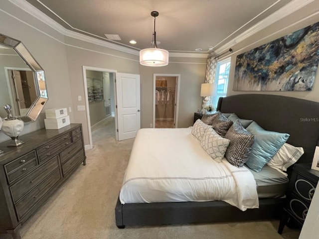 carpeted bedroom with a walk in closet and ornamental molding