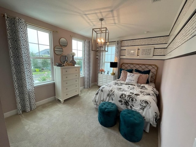 carpeted bedroom with multiple windows and an inviting chandelier