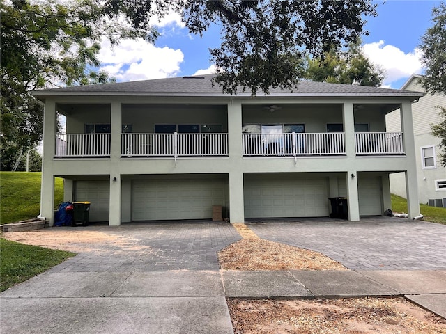 view of front facade with a garage and a balcony