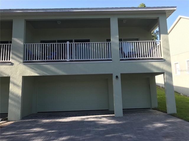 view of front of house with a balcony and a garage