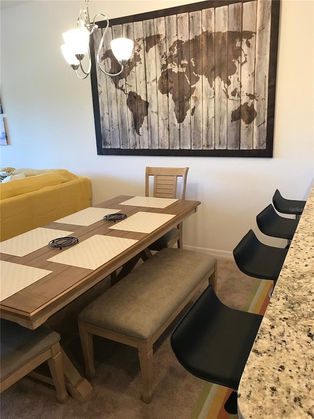 dining room featuring carpet flooring and an inviting chandelier