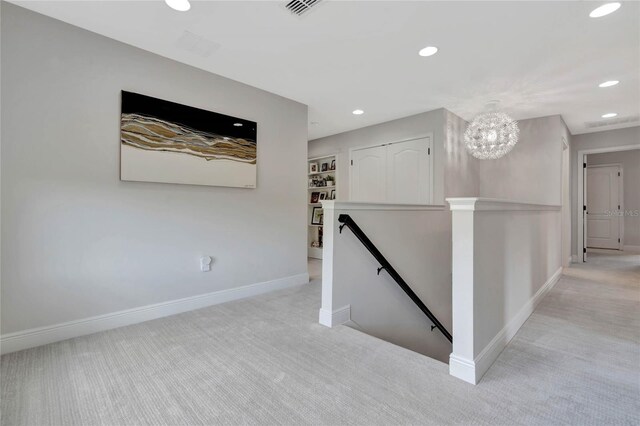 interior space with a notable chandelier and light carpet