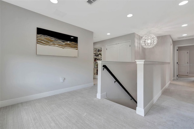 hallway featuring baseboards, recessed lighting, an upstairs landing, and light colored carpet