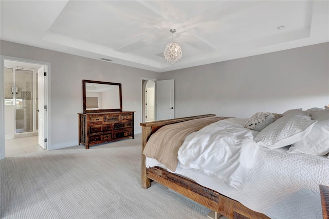 bedroom with light carpet, a tray ceiling, and visible vents