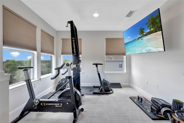 workout area with visible vents, baseboards, and carpet flooring