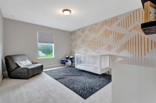 carpeted bedroom featuring baseboards and wallpapered walls