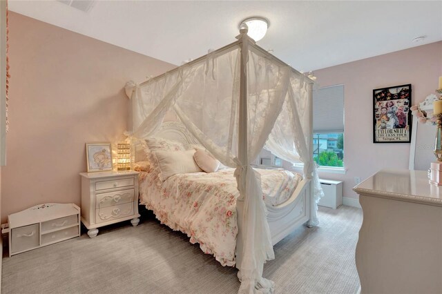 bedroom with light colored carpet