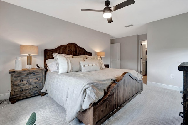 bedroom featuring light colored carpet, ceiling fan, visible vents, and baseboards