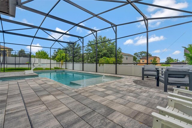 view of pool featuring a lanai, pool water feature, and a patio