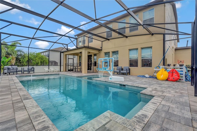 view of pool featuring pool water feature, a patio, and a lanai