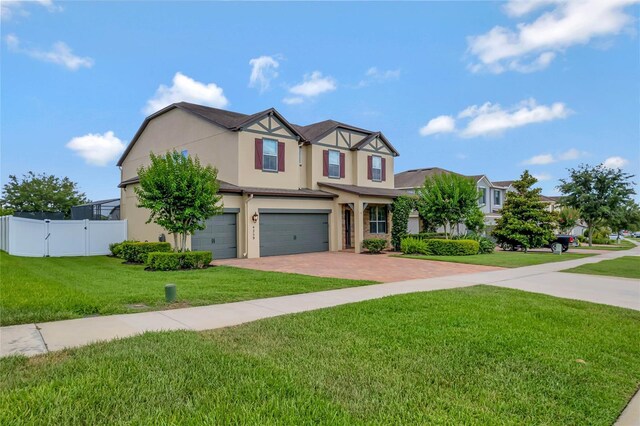 view of front of house featuring a garage and a front lawn