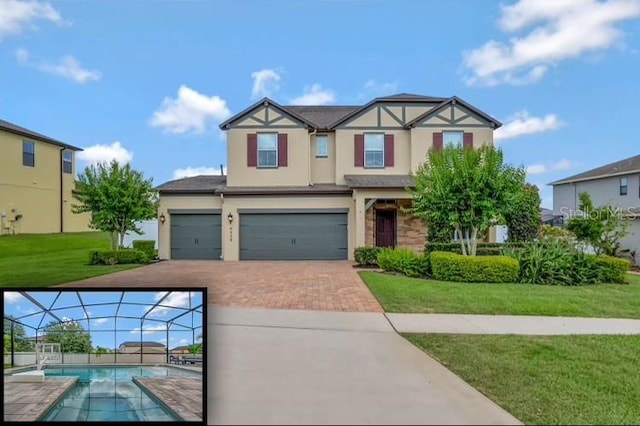 view of front of property with a garage and a front lawn