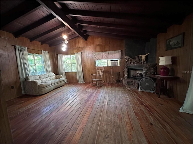 unfurnished living room with wood walls, lofted ceiling with beams, a fireplace, dark wood-type flooring, and wooden ceiling