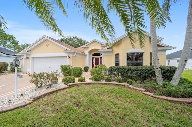 view of front of home with a front lawn and a garage