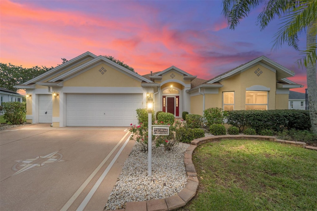 view of front of home with a yard and a garage