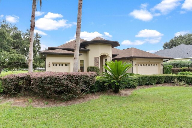 view of front of home with a garage and a front yard