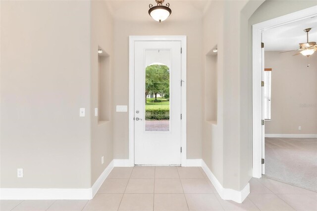 entrance foyer featuring light tile patterned floors and ceiling fan