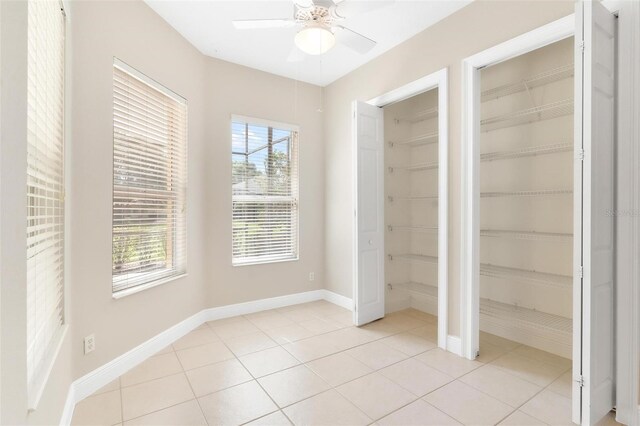 unfurnished bedroom featuring ceiling fan and light tile patterned floors