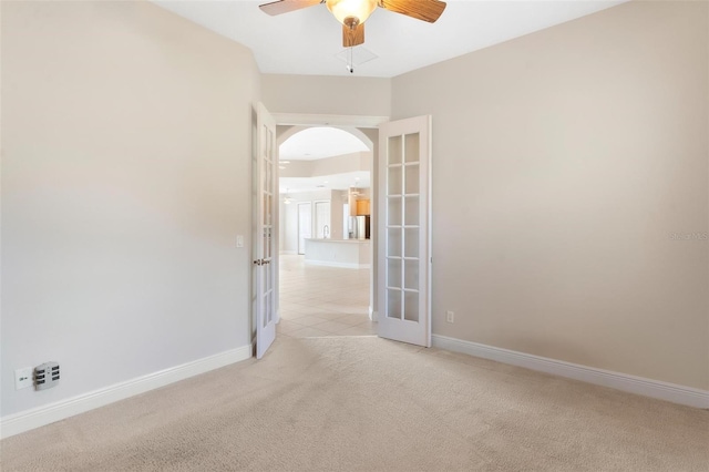 carpeted spare room with ceiling fan