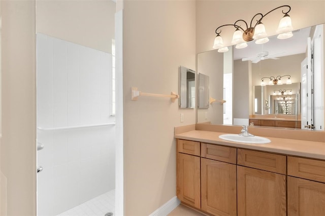 bathroom with tiled shower and vanity